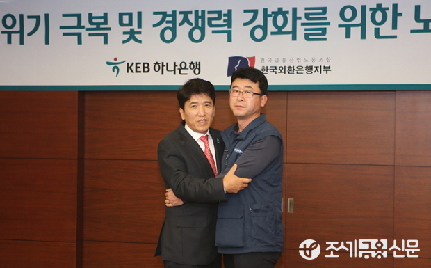 함영주 KEB하나은행장(사진 왼쪽)과 김근용 외환노조위원장(사진 오른쪽)이 '위기 극복을 위한 노사 상생 선언문'에 서명하고 기념사진을 촬영하고 있다.