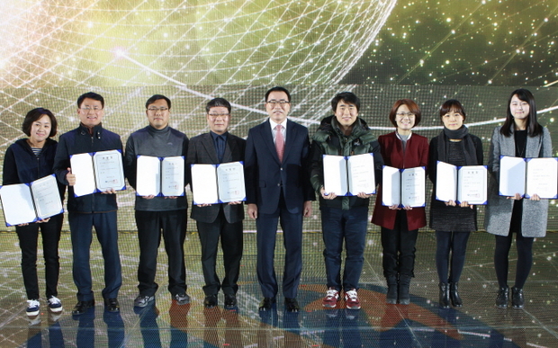 올림픽공원 체조경기장에서 진행된 신한은행 2015년 종합업적평가대회에서 조용병 신한은행장(가운데)과 특별승진자들이 사령장을 들고 기념사진을 찍고 있는 모습.